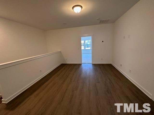 a view of a room with wooden floor and window