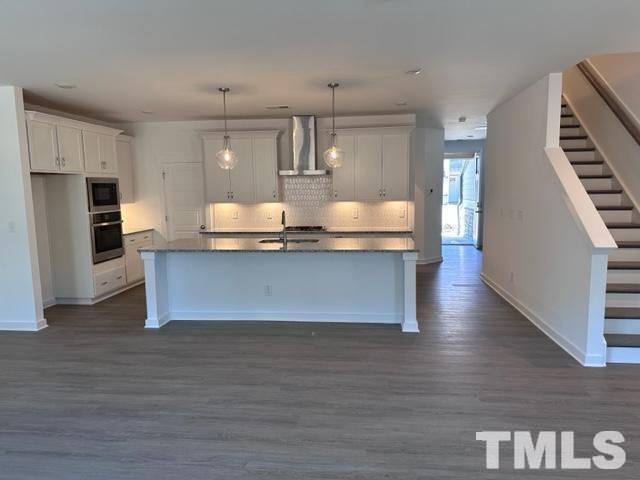 2155 Maggie Way Apex, NC 27502 - Photo 12 of 22 a large kitchen with wooden floors and stainless steel appliances