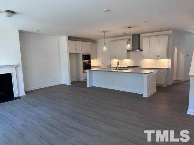 a view of kitchen with sink microwave and refrigerator