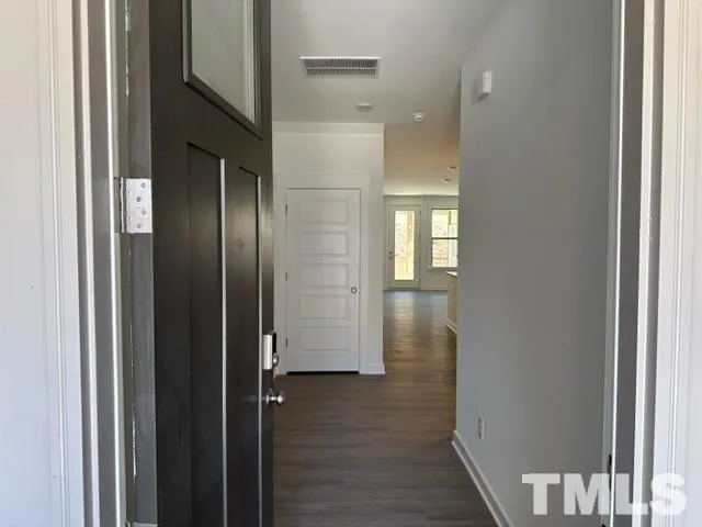 a view of hallway with wooden floor