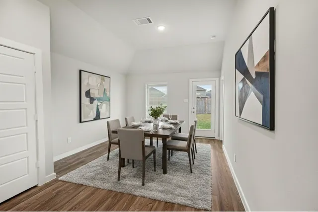 a view of a kitchen with a sink and wooden floor