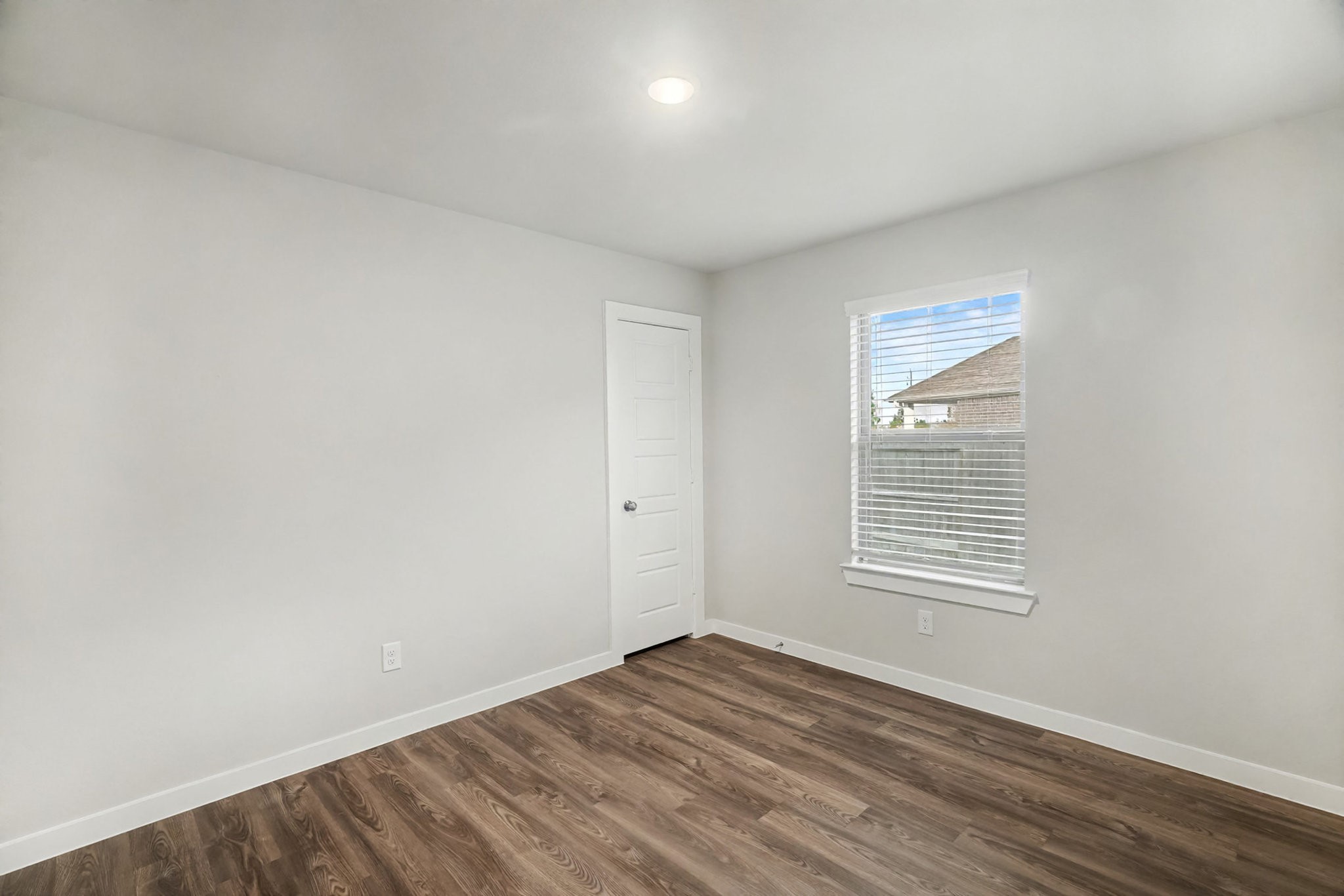 8427 Blue Shell Lane Cypress, TX 77433 - Photo 14 of 27 an empty room with wooden floor and windows