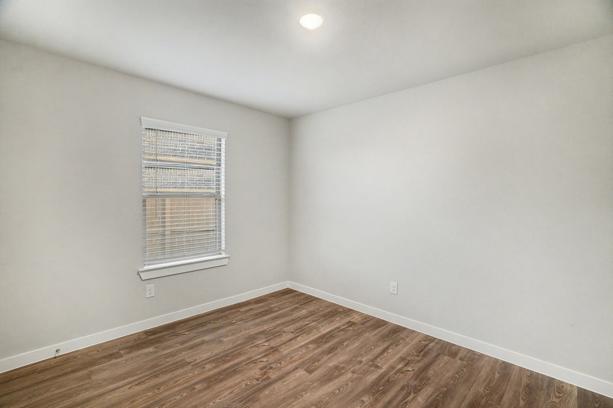 8427 Blue Shell Lane Cypress, TX 77433 - Photo 16 of 27 an empty room with wooden floor and windows