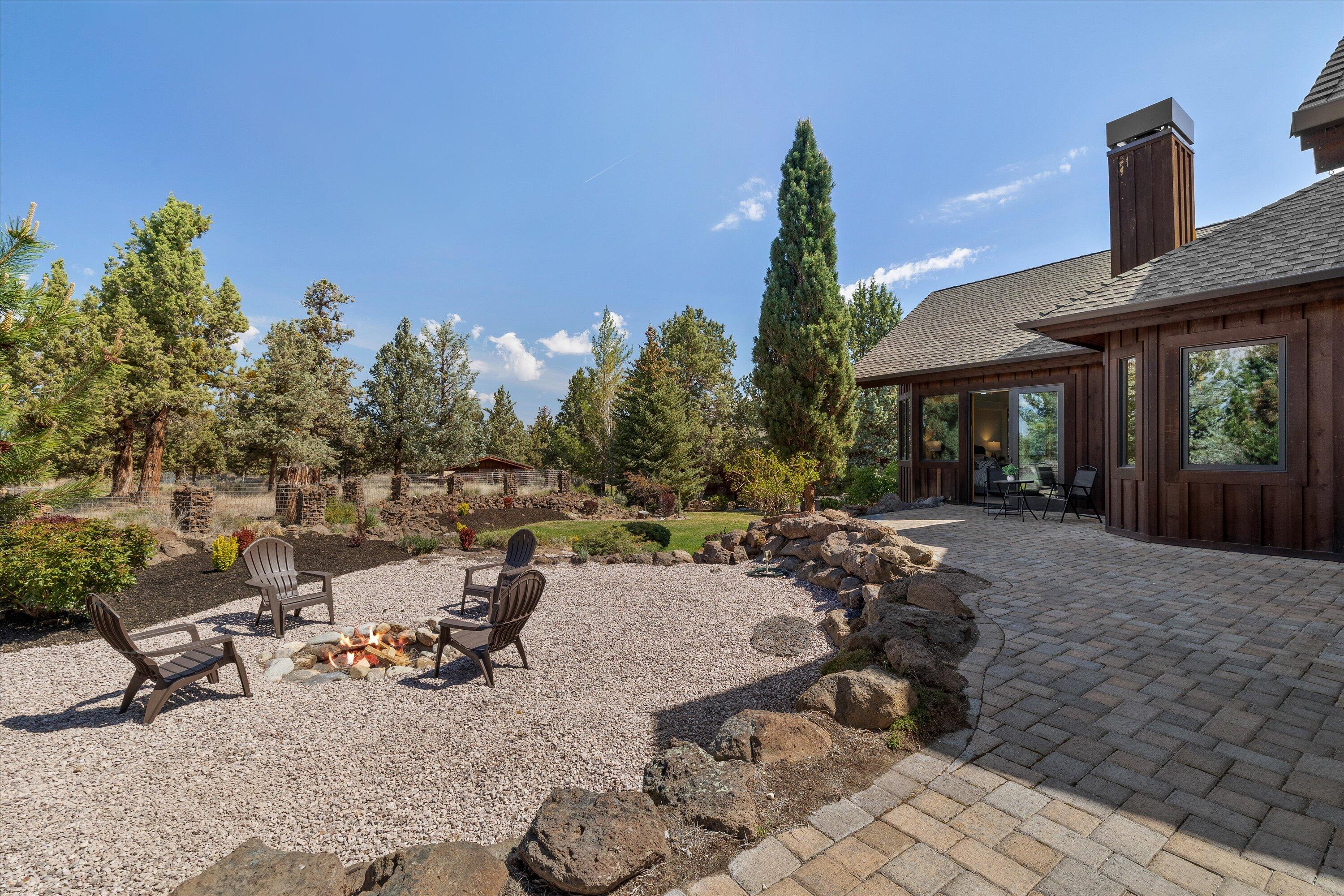 64155 Hunnell Road Bend, OR 97703 - Photo 46 of 96 The fire pit overlooking the side yard.