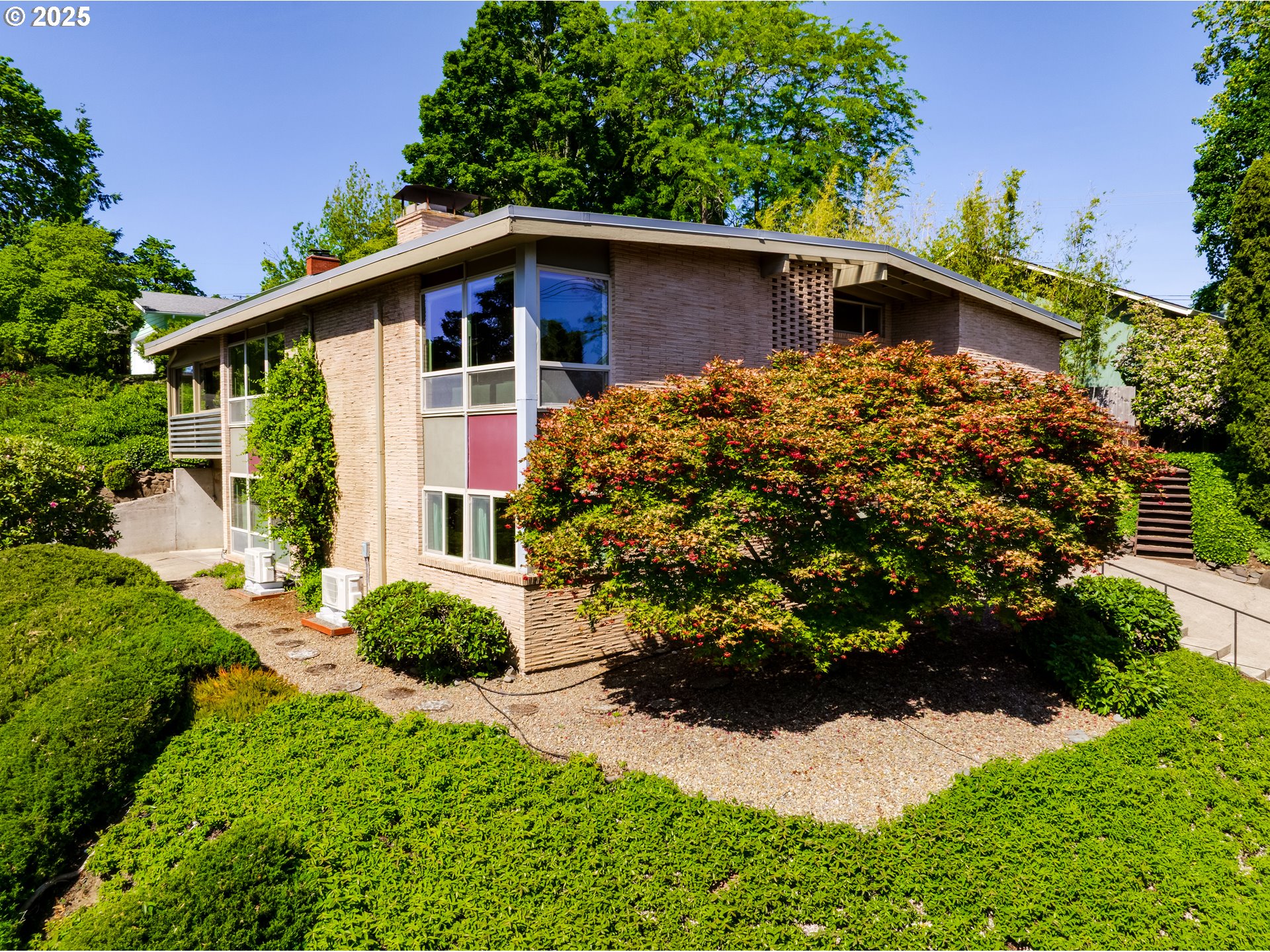 495 West 27th Avenue Eugene, OR 97405 - Photo 2 of 48 a front view of a house with a yard and potted plants