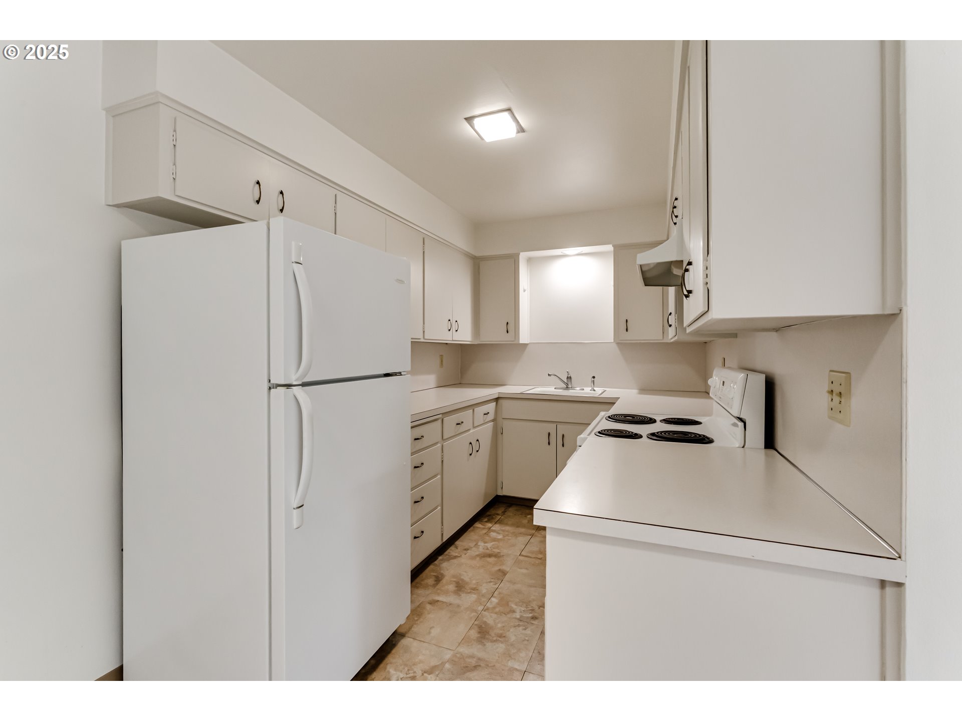 495 West 27th Avenue Eugene, OR 97405 - Photo 40 of 48 a kitchen with refrigerator a stove a sink and a cabinets