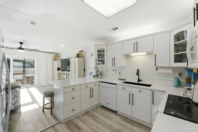 a kitchen with a sink stove and cabinets