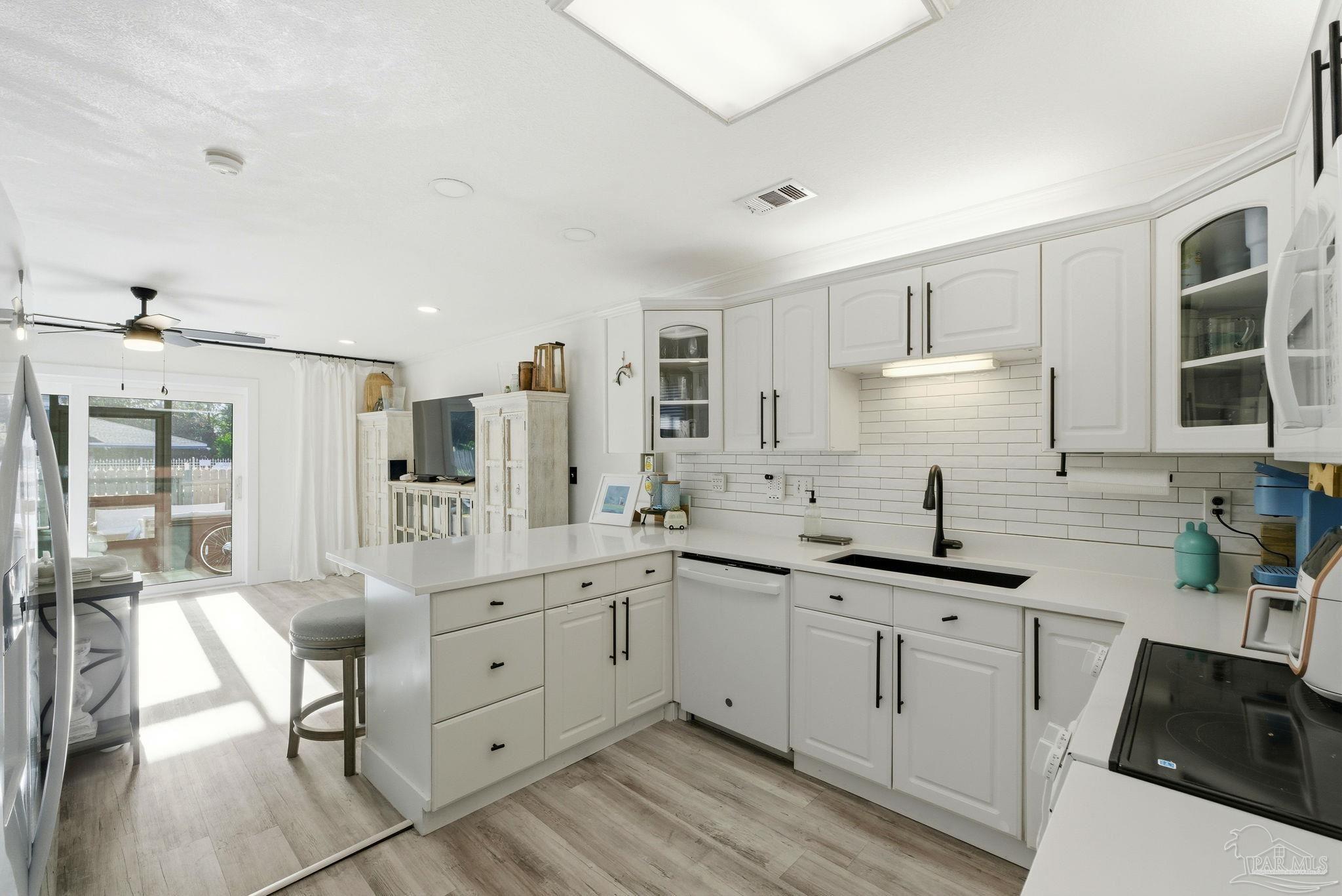 a kitchen with a sink stove and cabinets