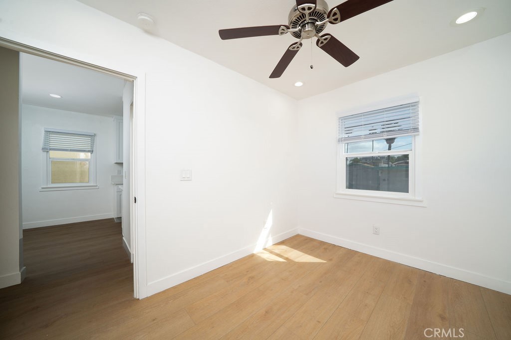 1050 Cedar Avenue Long Beach, CA 90813 - Photo 7 of 8 an empty room with wooden floor chandelier fan and windows