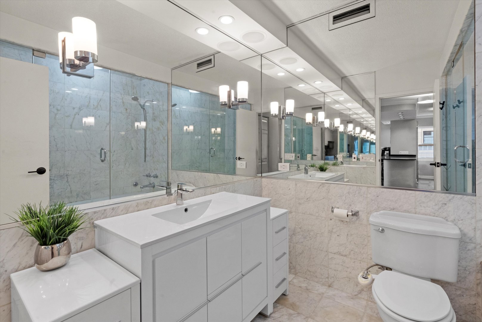 1313 North Ritchie Court, Unit 805 Chicago, IL 60610 - Photo 13 of 21 a bathroom with a sink a toilet and a mirror