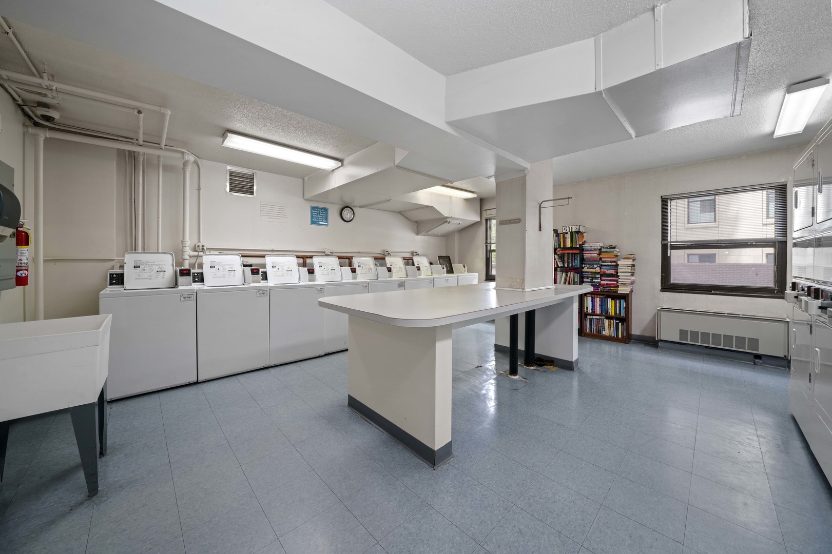 1313 North Ritchie Court, Unit 805 Chicago, IL 60610 - Photo 20 of 21 a room with kitchen island a sink and a large window