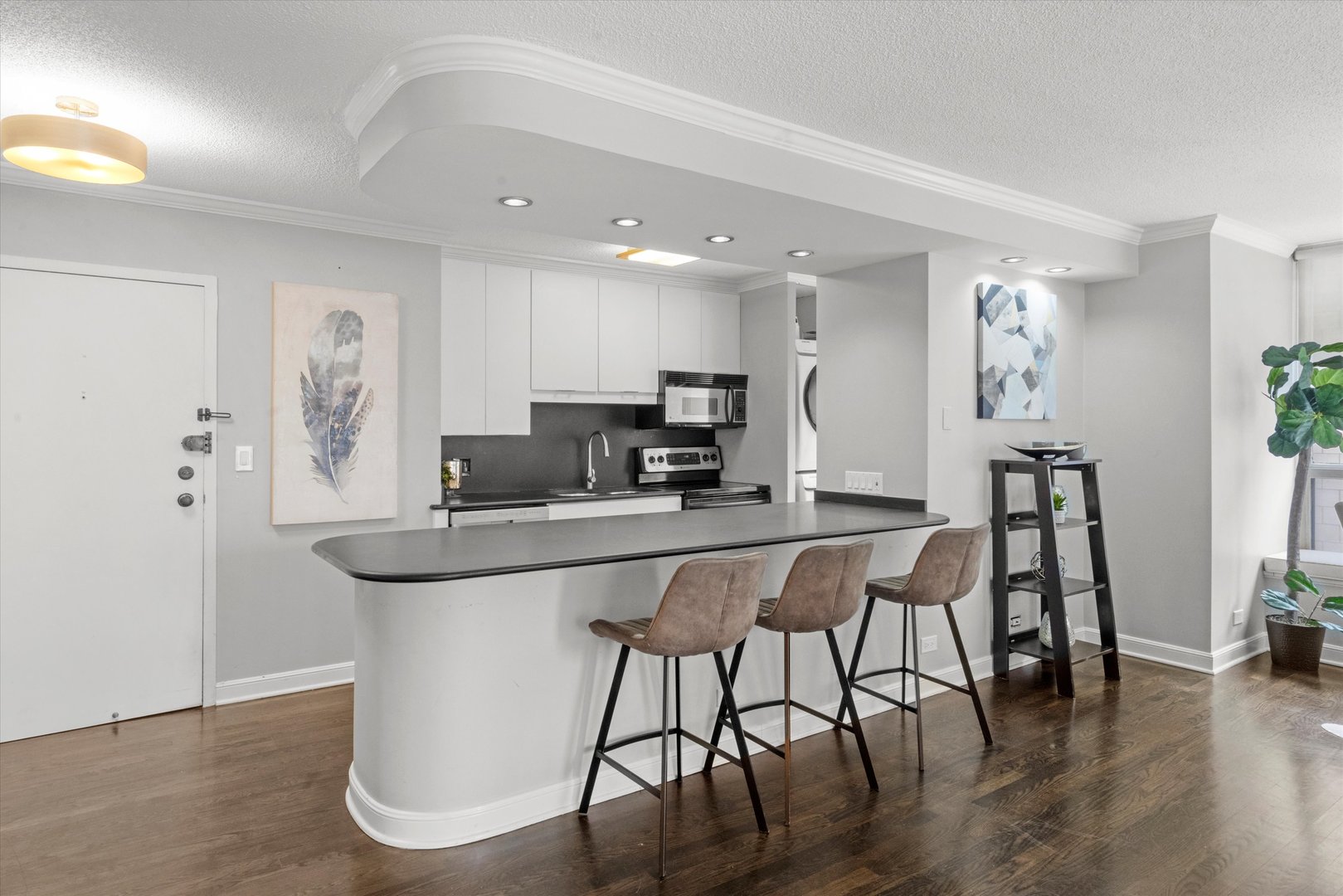 1313 North Ritchie Court, Unit 805 Chicago, IL 60610 - Photo 2 of 21 a kitchen with stainless steel appliances granite countertop a dining table chairs and granite counter tops