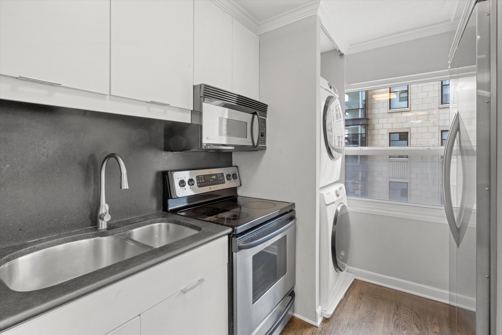 1313 North Ritchie Court, Unit 805 Chicago, IL 60610 - Photo 3 of 21 a kitchen with stainless steel appliances granite countertop a sink stove and refrigerator