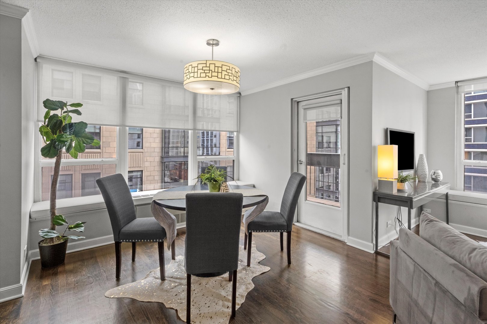 1313 North Ritchie Court, Unit 805 Chicago, IL 60610 - Photo 7 of 21 a view of a dining room with furniture window and wooden floor