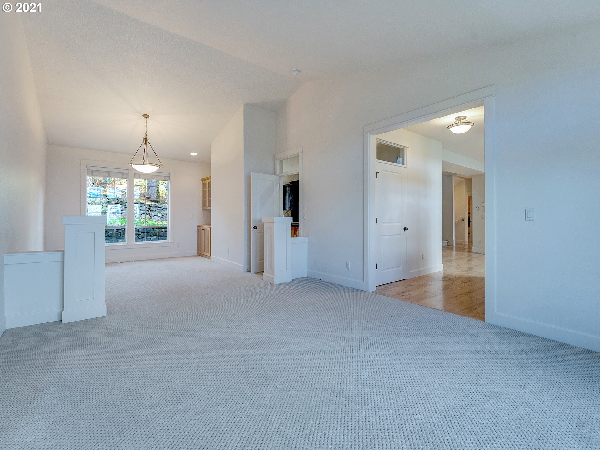 10248 Southeast Nicole Loop Happy Valley, OR 97086 - Photo 15 of 32 an empty room with chandelier fan and windows