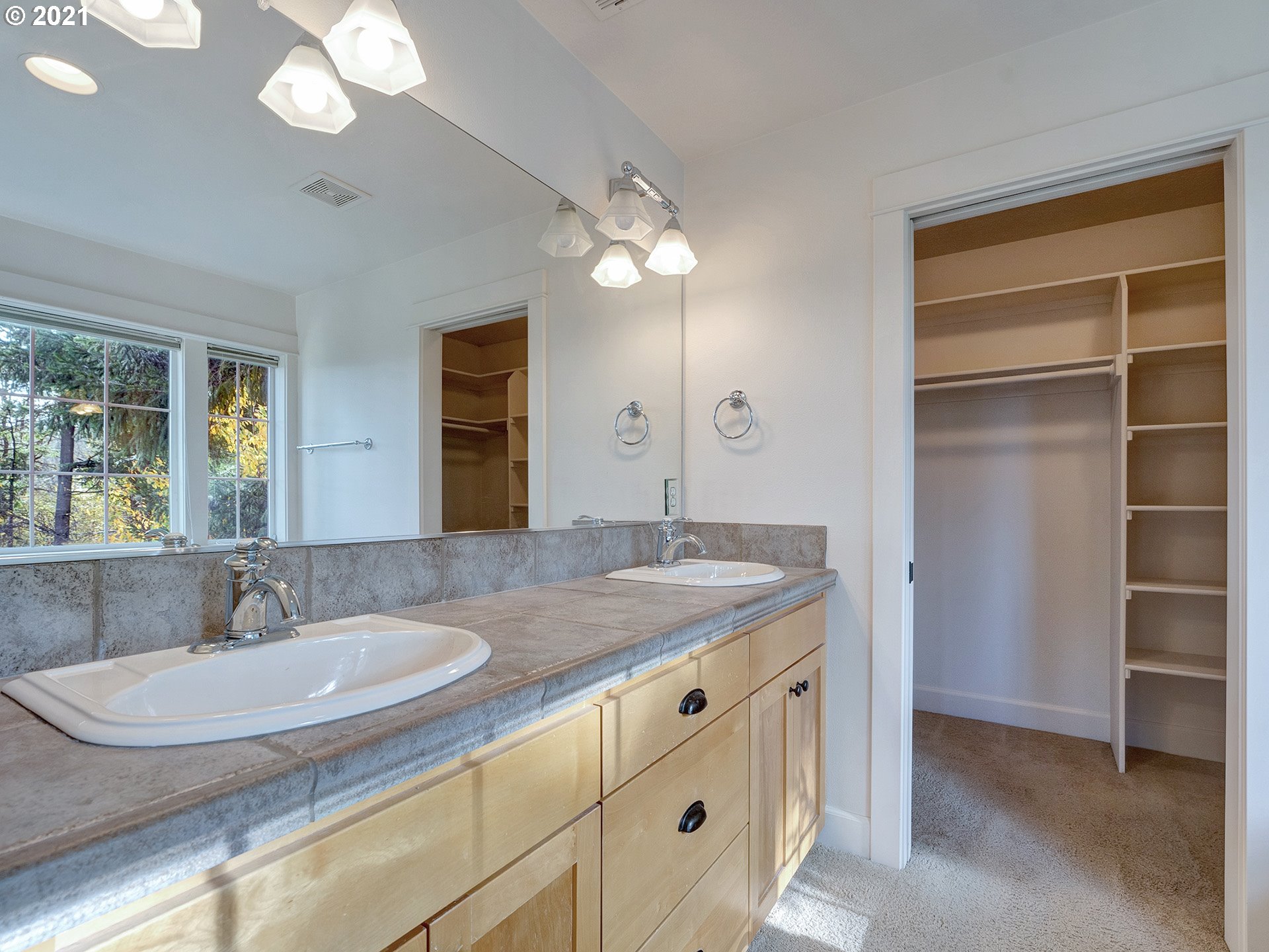 10248 Southeast Nicole Loop Happy Valley, OR 97086 - Photo 23 of 32 a bathroom with a granite countertop sink a light fixture and a mirror