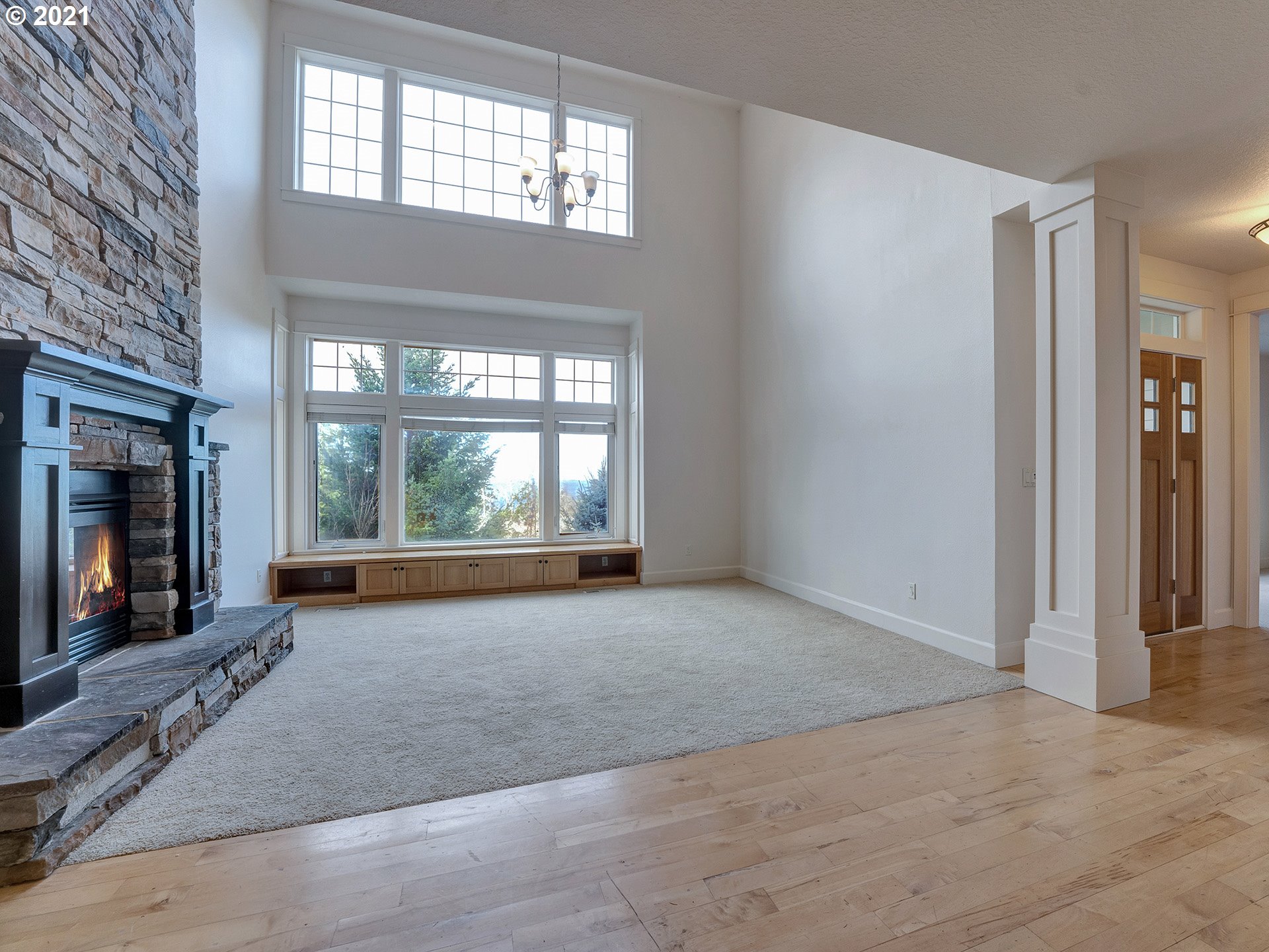 10248 Southeast Nicole Loop Happy Valley, OR 97086 - Photo 7 of 32 a view of an empty room with a fireplace and a window