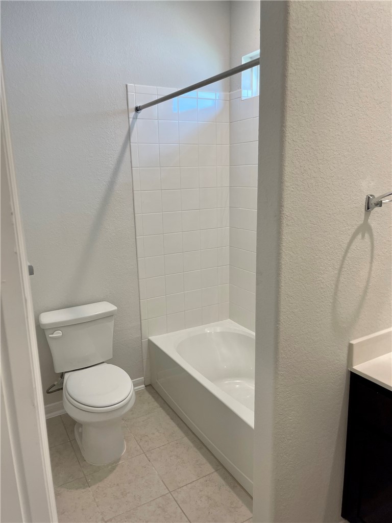 1003 Cherrystone Loop Buda, TX 78610 - Photo 16 of 27 a white toilet sitting next to a bath tub