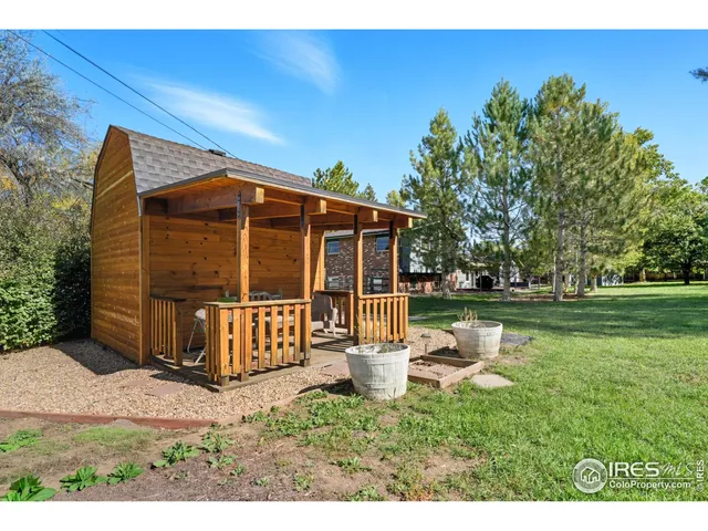 a view of a house with backyard sitting area and garden