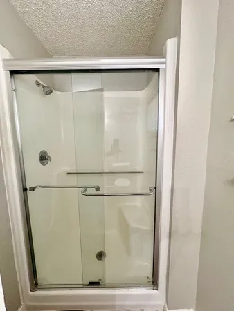a bathroom with a glass shower door