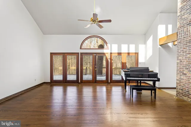 a living room with furniture a fireplace and a potted plant