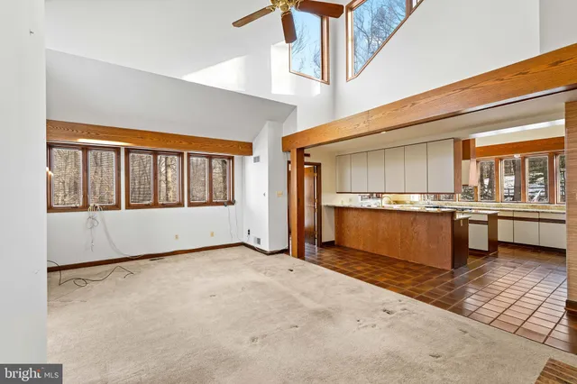 a spacious bedroom with a bed and a chandelier
