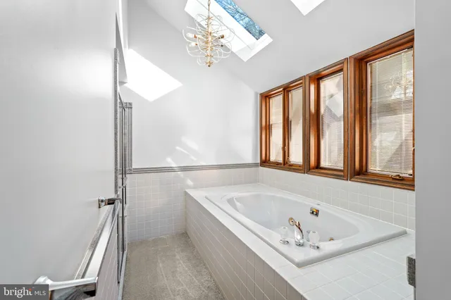 a view of an empty room with window and stairs