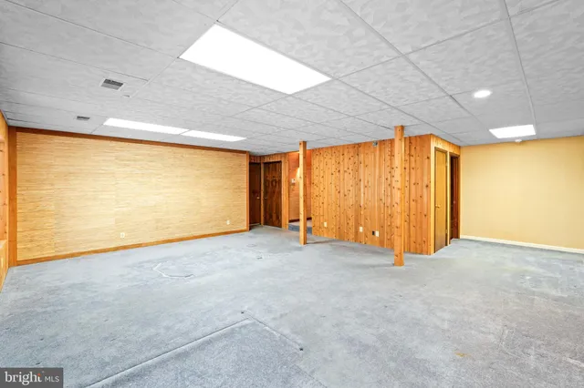 a view of a house with a yard and tree s