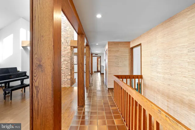 a view of a hallway with wooden floor and a fireplace