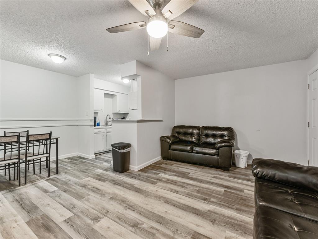 9464 Highway 180, Unit 1 Breckenridge, TX 76424 - Photo 4 of 11 a bedroom with a bed and wooden floor