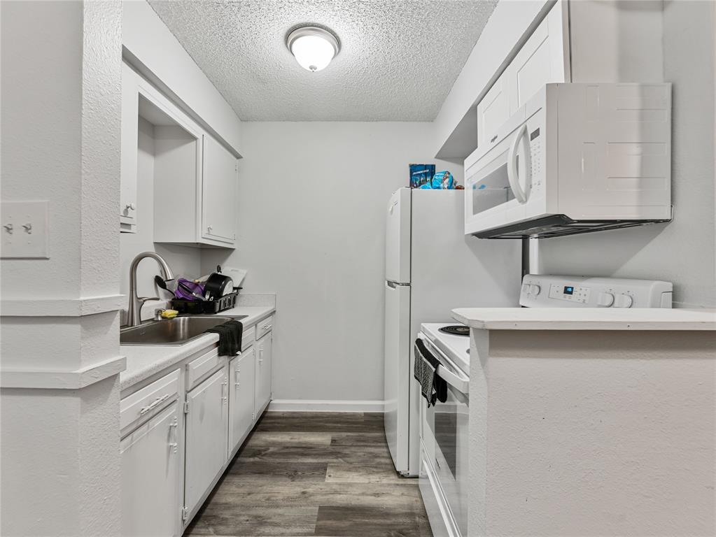 9464 Highway 180, Unit 1 Breckenridge, TX 76424 - Photo 5 of 11 a kitchen with a sink a stove and refrigerator