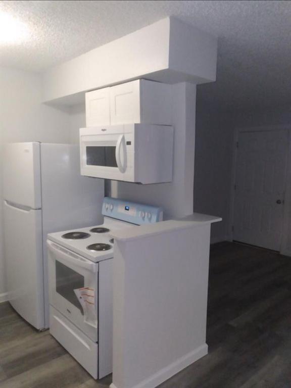 9464 Highway 180, Unit 1 Breckenridge, TX 76424 - Photo 7 of 11 a kitchen with a stove and a microwave