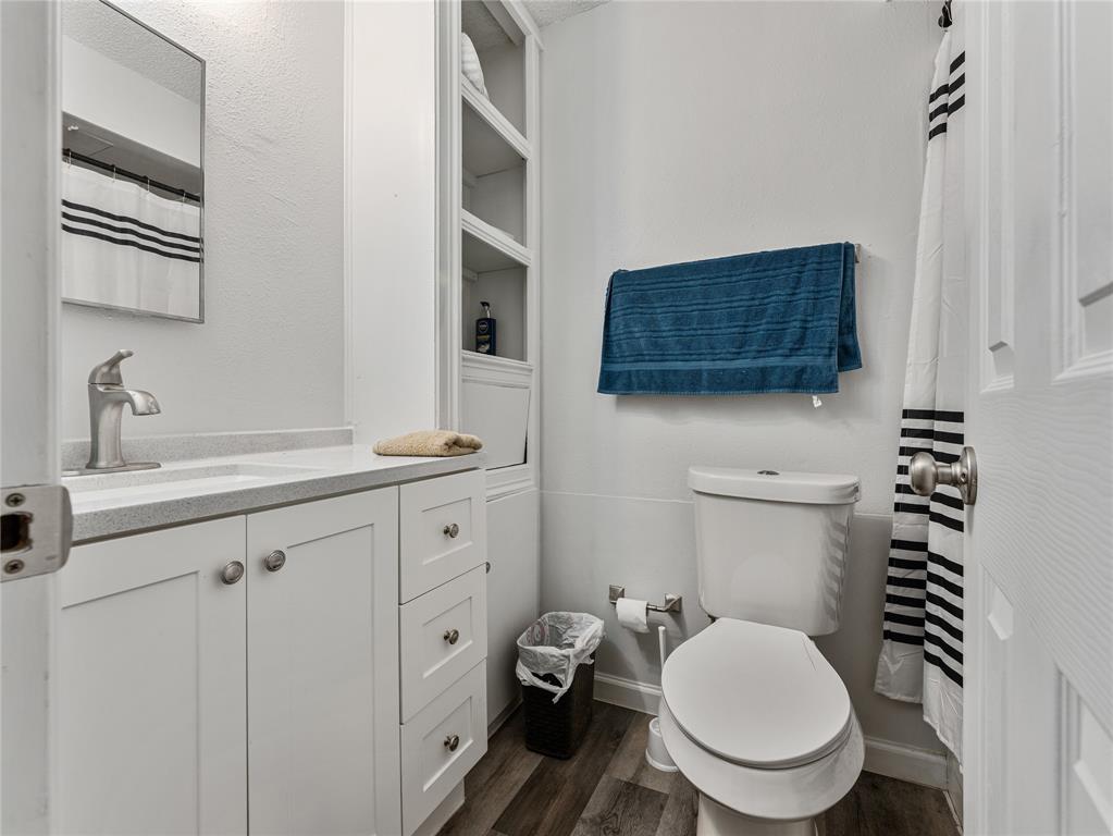 9464 Highway 180, Unit 1 Breckenridge, TX 76424 - Photo 10 of 11 a bathroom with a toilet a sink and mirror