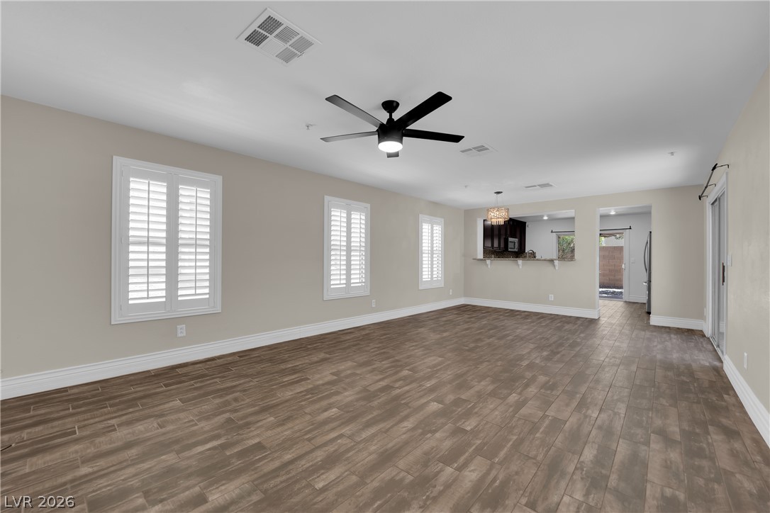 646 Monument Point Street Henderson, NV 89002 - Photo 8 of 44 An inviting open-concept living area boasts wood-look flooring and clean-lined plantation shutters.