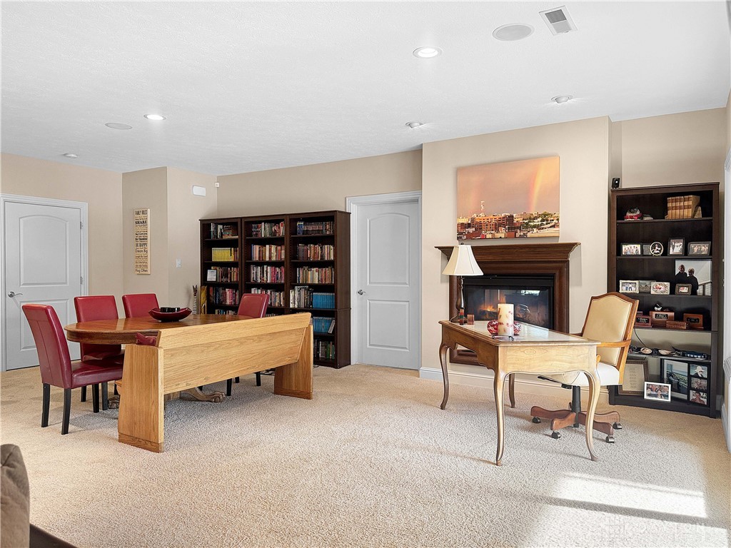 4096 Middle Urbana Road Urbana, OH 43078 - Photo 32 of 96 This versatile space features a cozy fireplace and extensive built-in shelving, perfect for a library or home office.