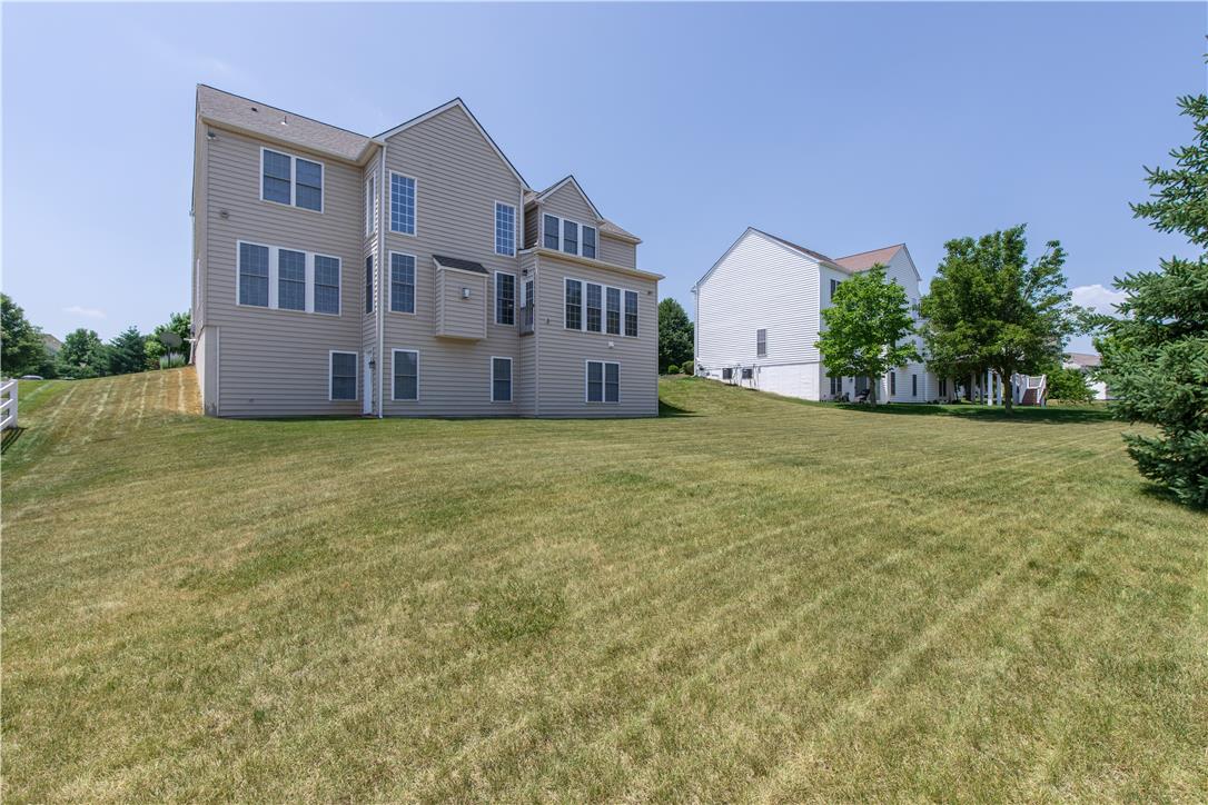 1709 Travers Road Breinigsville, PA 18031 - Photo 50 of 55 A spacious backyard provides ample green space for outdoor activities, complementing the home's rear elevation.