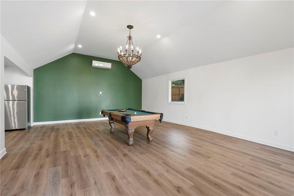 403 Rockbridge Road Southwest Lilburn, GA 30047 - Photo 67 of 77 a view of a dining room with furniture wooden floor and chandelier