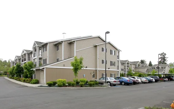 a front view of a house with a garden and parking