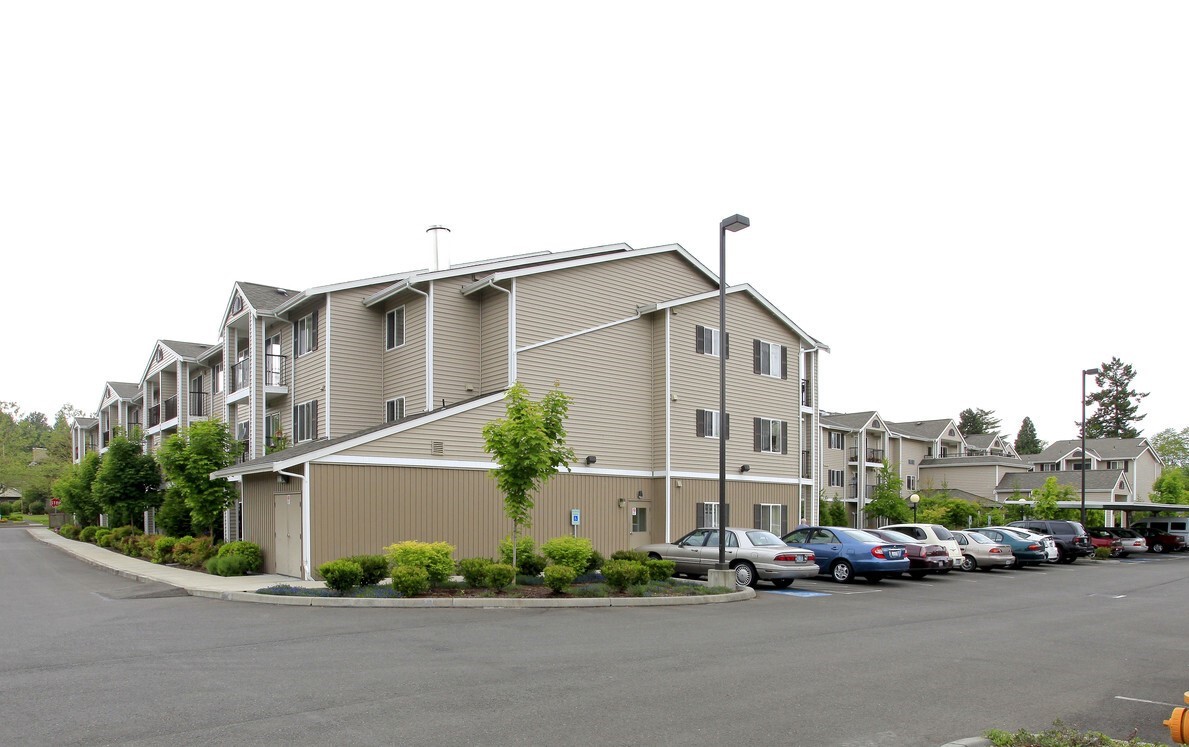 26404 104th Avenue Southeast, Unit 29 Kent, WA 98030 - Photo 7 of 13 a front view of a house with a garden and parking