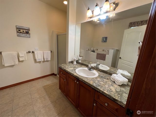 a bathroom with a double vanity sink and a mirror