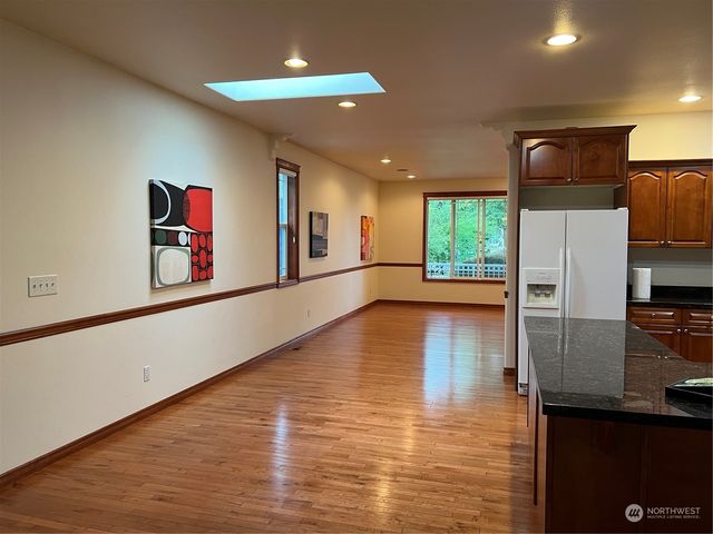 a kitchen with stainless steel appliances granite countertop a refrigerator and a stove top oven