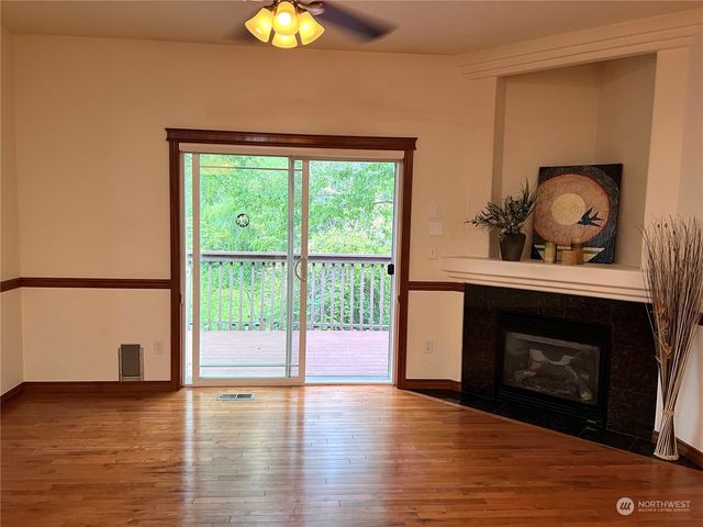 a living room with a fireplace and a floor to ceiling window