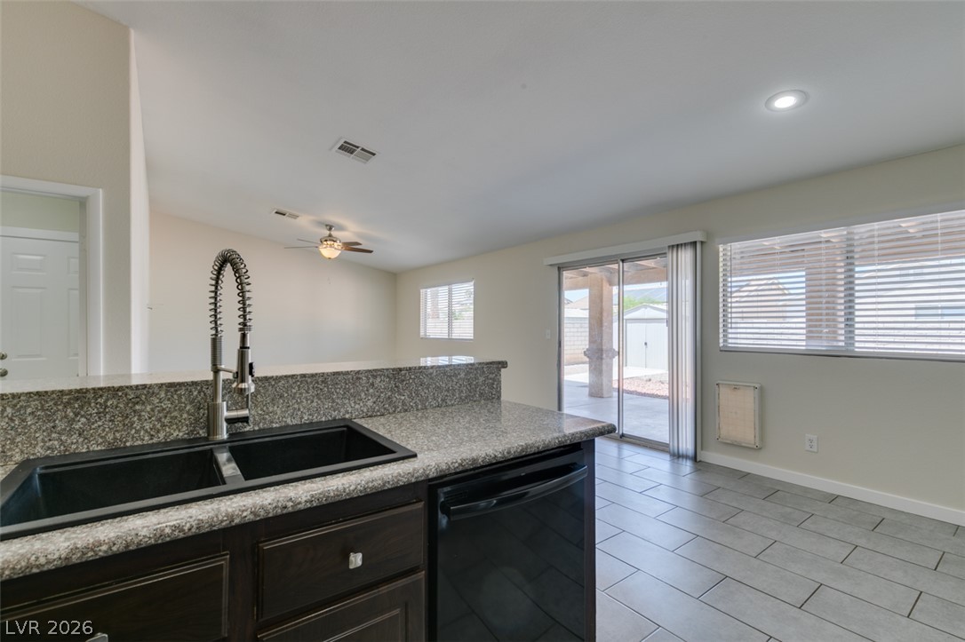 2028 Rustler Ridge Avenue North Las Vegas, NV 89031 - Photo 24 of 40 A well-appointed kitchen features a large double sink, granite counters, and ample storage cabinetry.