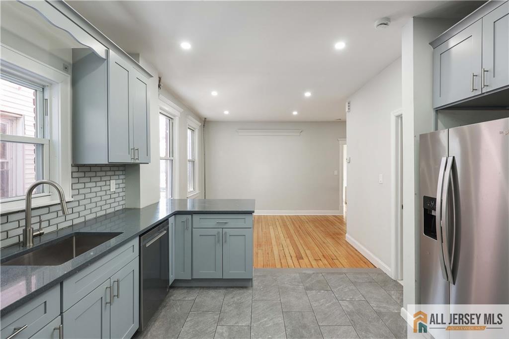 344 Market Street Perth Amboy, NJ 08861 - Photo 15 of 31 a kitchen with granite countertop a sink stainless steel appliances and cabinets