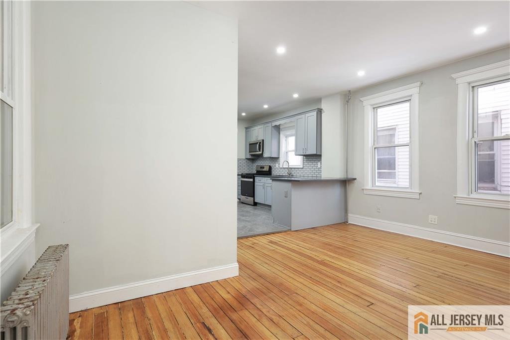 344 Market Street Perth Amboy, NJ 08861 - Photo 7 of 31 a big room with wooden floor and windows