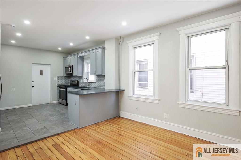 344 Market Street Perth Amboy, NJ 08861 - Photo 8 of 31 a kitchen with stainless steel appliances granite countertop a stove a sink and a refrigerator