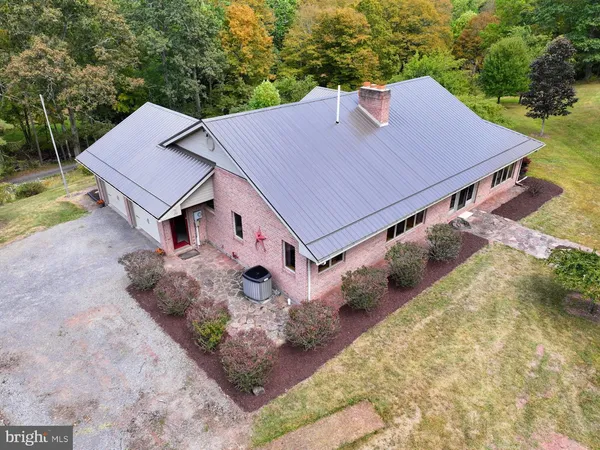 an aerial view of a house with a yard