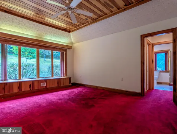 a view of a small space with wooden floor and windows