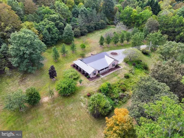 an aerial view of a house with a yard