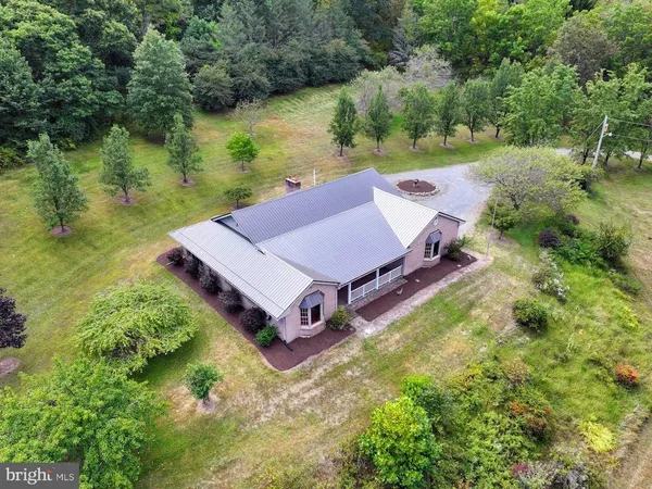 an aerial view of a house with garden space and lake view